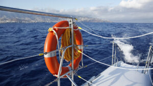 photo of a sail boat and life preserver- text reads Boat Insurance Reardon Insurance Agency